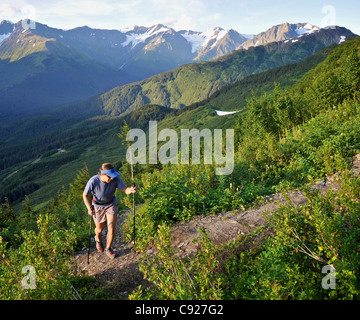 Woman hikes the steep North Face Trail at Alyeska Resort in Girdwood, Southcentral Alaska, Summer Stock Photo