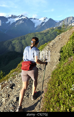 Woman hikes the steep North Face Trail at Alyeska Resort in Girdwood, Southcentral Alaska, Summer Stock Photo