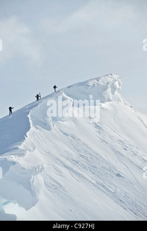 Backcountry skiers on the ridge of PMS Bowl in Turnagain Pass, Chugach National Forest Southcentral Alaska, Winter