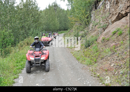 ATV riders on a trail in the Matanuska Valley with Alaska Backcountry Adventure Tours near Palmer, Southcentral Alaska, Autumn Stock Photo