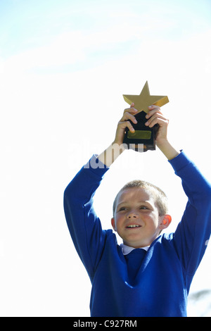 Student cheering with trophy Stock Photo