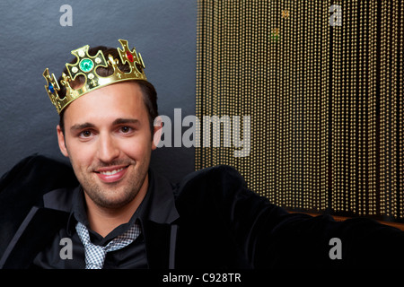 Smiling man wearing plastic crown Stock Photo