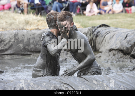 The quirky annual Mud Wrestling Championships, held at The Lowland Games festival, end of July in Thorney, Somerset, England Stock Photo