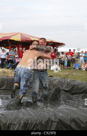 The quirky annual Mud Wrestling Championships, held at The Lowland Games festival, end of July in Thorney, Somerset, England Stock Photo