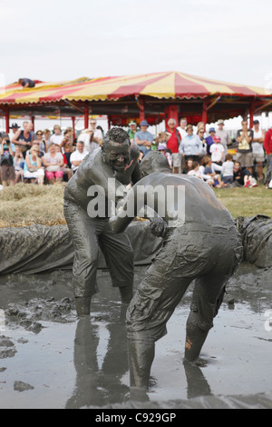 The quirky annual Mud Wrestling Championships, held at The Lowland Games festival, end of July in Thorney, Somerset, England Stock Photo