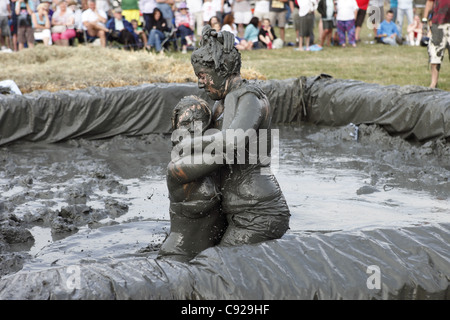 The quirky annual Mud Wrestling Championships, held at The Lowland Games festival, end of July in Thorney, Somerset, England Stock Photo