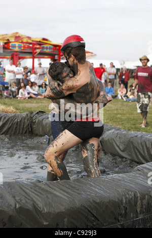 The quirky annual Mud Wrestling Championships, held at The Lowland Games festival, end of July in Thorney, Somerset, England Stock Photo