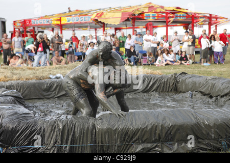 The quirky annual Mud Wrestling Championships, held at The Lowland Games festival, end of July in Thorney, Somerset, England Stock Photo