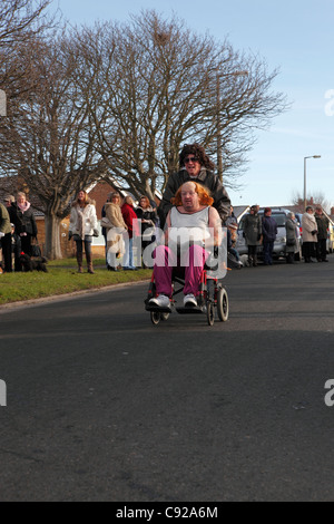 The quirky annual Pagham Pram Race, held annualy on Boxing Day, 26th Dec, in the village of Pagham, West Sussex, England Stock Photo