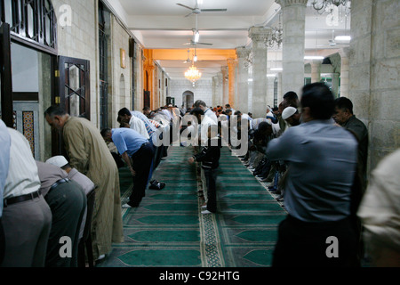 People praying at King Hussein (Al Husseiny) mosque in downtown Amman, Jordan. Stock Photo