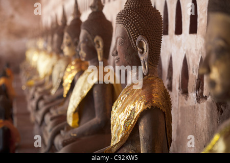 Ancient Buddha images line the courtyard walkway at Wat Si Saket in Vientiane, Laos. Stock Photo