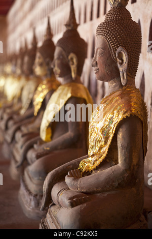 Ancient Buddha images line the courtyard walkway at Wat Si Saket in Vientiane, Laos. Stock Photo