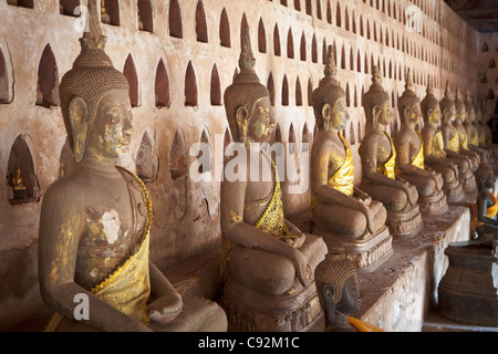 Ancient Buddha images line the courtyard walkway at Wat Si Saket in Vientiane, Laos. Stock Photo