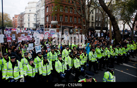 London, UK. 9th Nov 2011. Student protesters march through London escorted by police.  The students are protesting against an increase in tuition fees and Government budget cuts. Stock Photo