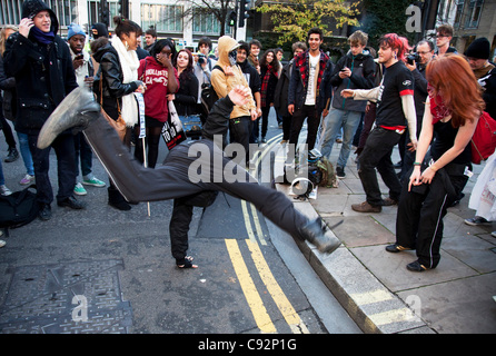 Anarchists dancing during student march through central London to protest against rises in tuition fees and changes to higher education. The police were out in force as thousands of students marched through central London. Some 4,000 officers were on duty, as demonstrators marched peacefully in a pr Stock Photo