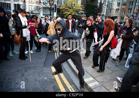 Anarchists dancing during student march through central London to protest against rises in tuition fees and changes to higher education. The police were out in force as thousands of students marched through central London. Some 4,000 officers were on duty, as demonstrators marched peacefully in a pr Stock Photo