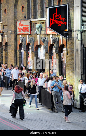 Looking down group of people waiting in line queuing to buy tickets to enter the London Dungeon visitor attraction Tooley Street London England UK Stock Photo