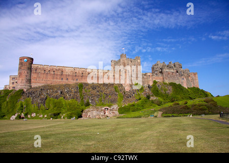 Bamburgh Castle is one of the largest inhabited castles in the UK built on a basalt outcrop overlooking the cricket pitch. Stock Photo