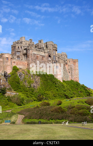 Bamburgh Castle is one of the largest inhabited castles in the UK built on a basalt outcrop overlooking the cricket pitch. Stock Photo