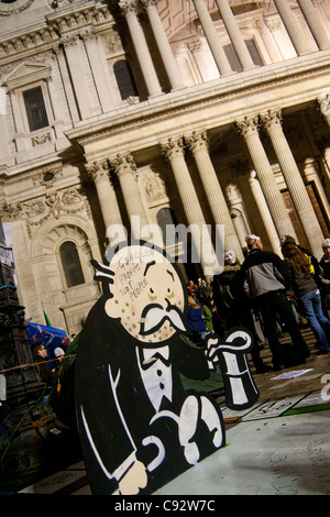 Occupy London protest outside St Paul's Cathedral butler figure holding hat with slogan 'Google Profits Not People' London Stock Photo