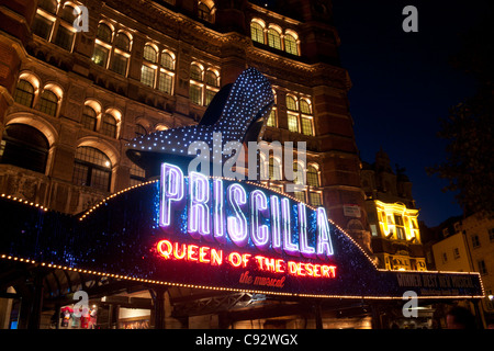 Palace Theatre at night with high heeled shoe and neon sign advertising Priscilla Queen of the Desert musical London England UK Stock Photo