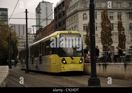 Yellow Metrolink tram at stop in St Peter's Square Manchester Stock Photo