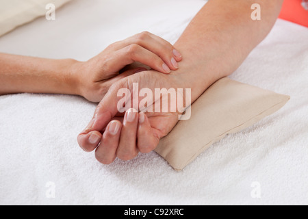Pulse being taking on a middle aged woman's wrist Stock Photo