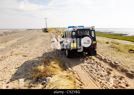 Sea storm coastal erosion at Spurn Head, Yorkshire east coast England. RNLI landrover on damaged narrowest point of sand spit Stock Photo