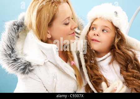 Portrait of mother and her daughter in warm winter clothes Stock Photo