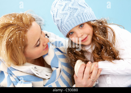 Portrait of mother and her daughter in warm winter clothes Stock Photo