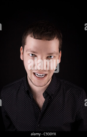 Portrait of anger man look at you from dark Stock Photo