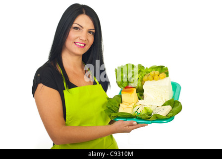 Happy market worker woman holding plateau with different cheese and grapes isolated on white background Stock Photo