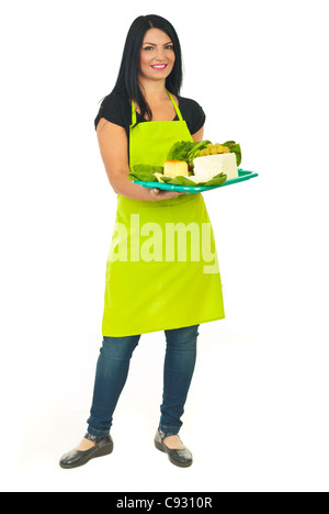 Full length of attractive cheese maker female holding full plateau with different type of cheese isolated on white background Stock Photo