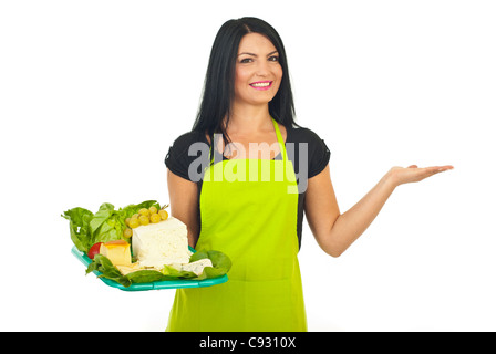 Beauty cheese maker woman holding plateau with different cheeses and making presentation to right part of image isolated Stock Photo