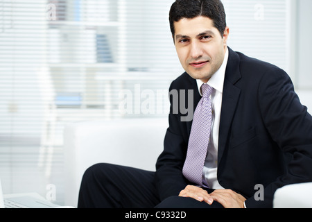 Portrait of attractive businessman in suit looking at camera Stock Photo