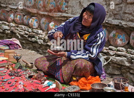 A souvenir seller waiting for tourists outside Kurjey Lhakhang, a complex of three temples. Stock Photo