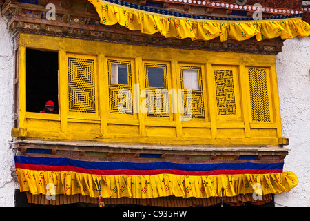 India, Ladakh, Likir. Small child watching the winter festival in the courtyard of Likir Monastery. Stock Photo