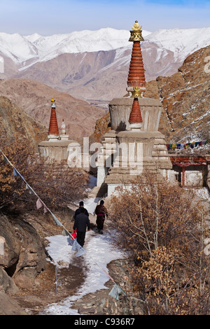 India, Ladakh, Hemis. Pilgrims circumambulating chortens at Hemis Monastery Stock Photo