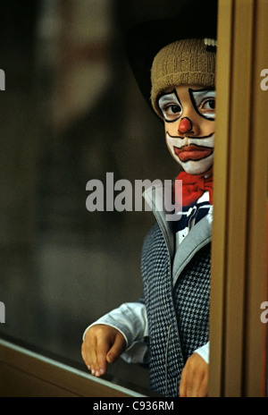 serious young boy dressed up as clown Stock Photo