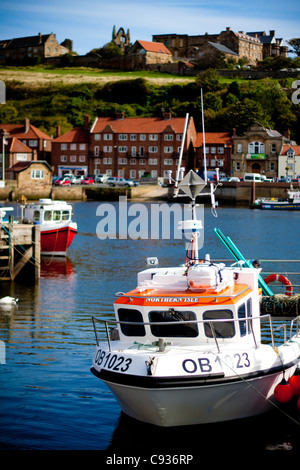 Whitby by the sea, with the boats at the docks and dockyard showing the beautiful scenic views with the abbey in the distance. Stock Photo