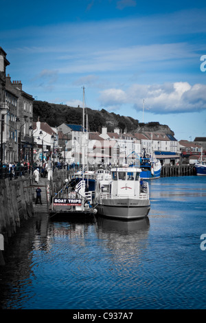 Whitby by the sea, with the boats at the docks and dockyard showing the beautiful scenic views with the sea in the distance. Stock Photo