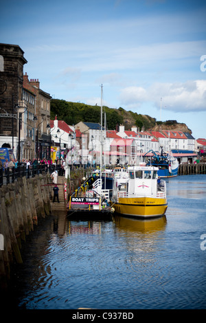 Whitby by the sea, with the boats at the docks and dockyard showing the beautiful scenic views with the boats in the distance. Stock Photo