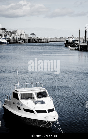 Whitby by the sea, with the boats at the docks and dockyard showing the beautiful scenic views with the sea in the distance. Stock Photo