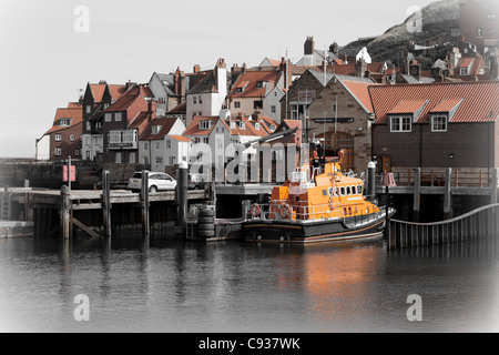 Whitby by the sea, with the boats at the docks and dockyard showing the beautiful views with the lifeboat in the distance. Stock Photo