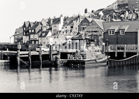 Whitby by the sea, with the boats at the docks and dockyard showing the beautiful views with the lifeboat in the distance. Stock Photo