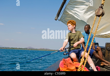 Malawi, Lake Malawi National Park.  Young boy fishing during a trip on  Lake Malawi. Stock Photo