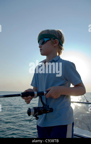 Malawi, Lake Malawi National Park.  Young boy fishing during a trip on  Lake Malawi on a speedboat from Pumulani Lodge. (MR) Stock Photo