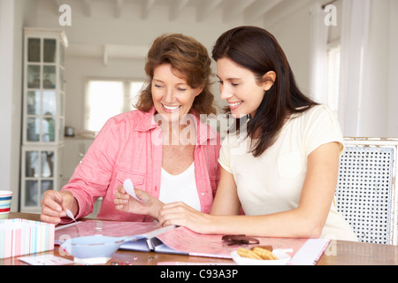 Adult mother and daughter scrapbooking Stock Photo