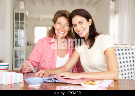 Adult mother and daughter scrapbooking Stock Photo