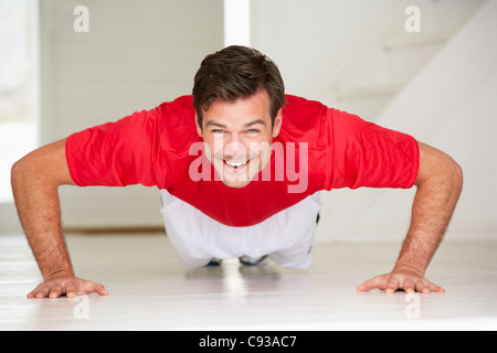 Man doing push-ups in home gym Stock Photo